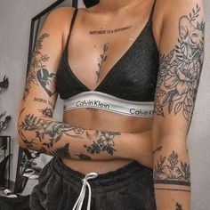 a woman with tattoos on her arms and chest