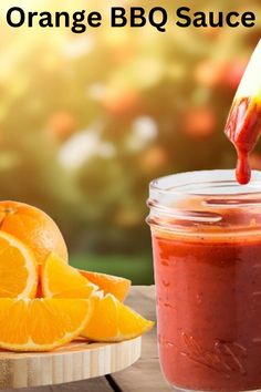 an orange bbq sauce is being poured into a jar