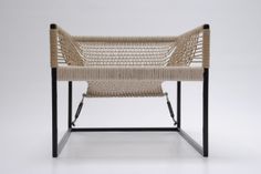 a chair made out of woven material and metal frame, with the seat folded back