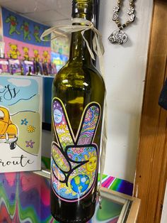 a glass bottle with an image of a butterfly painted on it sitting on a table