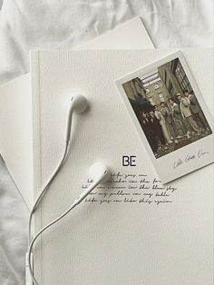 an old photo with headphones is laying on top of a note and postcard