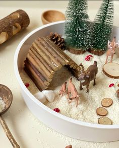 a white bowl filled with toys and snow