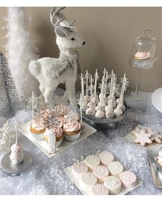 a table topped with cupcakes and desserts covered in frosted icing