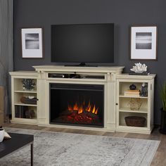 a living room with a fireplace and entertainment center