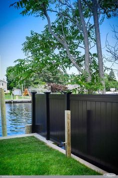 a fenced in area next to a body of water