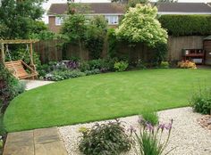 a garden with grass and gravel in the middle