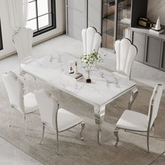 a marble dining table with white chairs around it