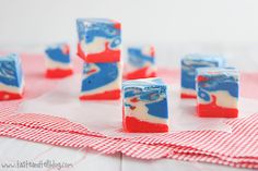 red, white and blue jellopops sitting on top of a checkered table cloth