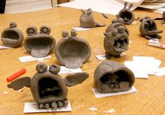 clay sculptures are sitting on the table and ready to be put into their own homes