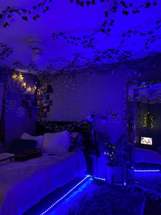 a bedroom with blue lights and decorations on the ceiling