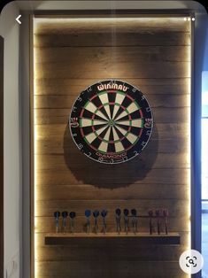 a dart board mounted to the side of a wooden wall