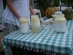 two jars of milk sitting on top of a table