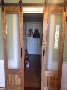 two wooden doors are open in the hallway