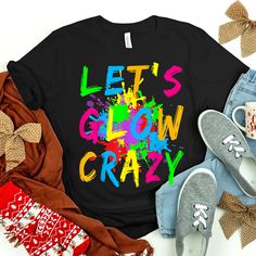 Buy Let’s Glow Crazy Colorful Party Shirt at Fantasywears. Hight quality products with perfect design is available in a spectrum of colors and sizes, and many different types of shirts! Unisex T-Shirt – 100% Cotton (fiber content may vary for different colors) – Medium fabric (5.3 oz/yd² (180 g/m²)) – Classic fit – Tear away the label – Runs true to size Women T-Shirt – 100% combed ringspun cotton (fiber content may vary for different colors) – Light fabric (4.3 oz/yd² (146 g/m²)) – Slim fit with a longer body length – Tear away the label – Runs smaller than [...] Colorful Trendy Party Tops, Trendy Colorful Party Tops, Fun Multicolor Party Tops, Fun Multicolor Tops For Party, Multicolor Short Sleeve Party Shirt, Multicolor Letter Print Tops For Party, Multicolor Graphic Print Shirt For Festivals, Multicolor Graphic Print Festival Shirt, Fun Black Party T-shirt