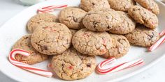 chocolate chip cookies and candy canes on a white plate