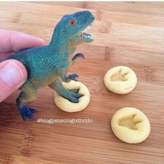 a small toy dinosaur on top of some cookies