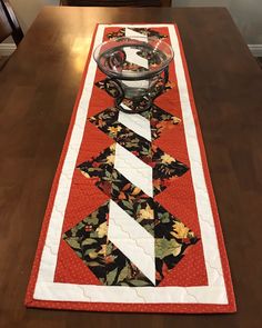 a table runner with a glass bowl on it