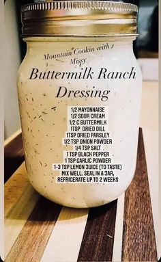 a jar of buttermilk ranch dressing sitting on a counter top with instructions to make it