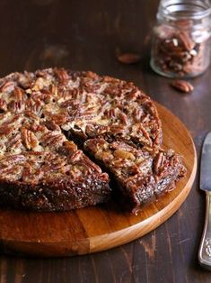 a pecan pie on a wooden cutting board