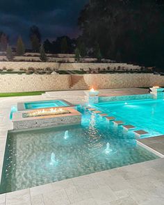 an outdoor fire pit in the middle of a swimming pool with steps leading up to it