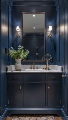 an elegant bathroom with blue walls and gold faucets on the sink countertop