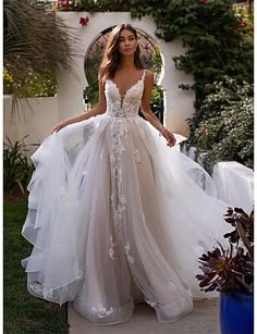 a woman in a wedding dress standing outside