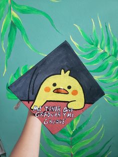 someone is holding up a graduation cap with an angry bird on it