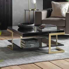 a coffee table with books on it in a living room