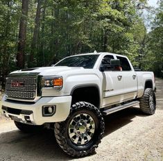 a white truck is parked in the woods