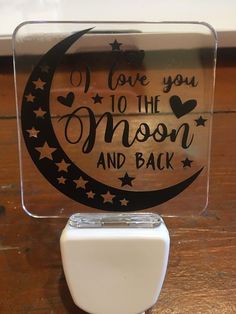 a glass block that says i love you to the moon and back