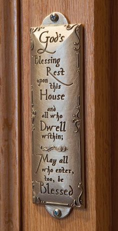 a metal plaque on the side of a wooden door saying god's blessing to rest in his house