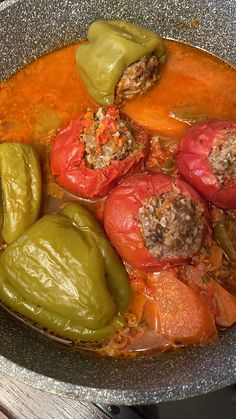 peppers and meat are cooking in a pot