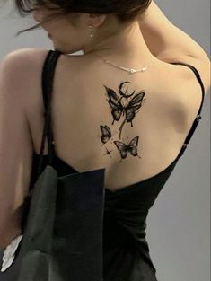 a woman with a butterfly tattoo on her back