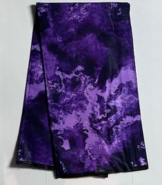 two purple and black tie - dyed napkins sitting on top of each other