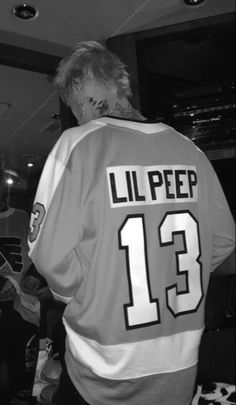 a man in an orange and white hockey jersey