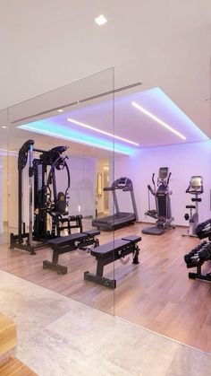 a gym with treadmills and exercise equipment in the center, as well as mirrors