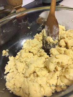 a wooden spoon mixing food in a bowl