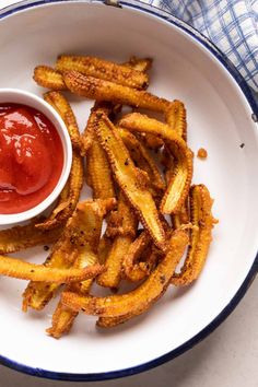 french fries with ketchup in a white bowl