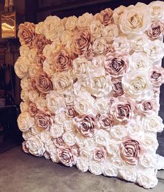 a large flower wall made out of white and pink flowers