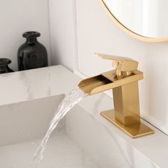 a faucet with water running from it in front of a white counter top