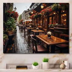 an outdoor restaurant with tables and chairs on the sidewalk, surrounded by potted plants