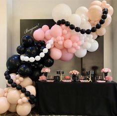 a table topped with lots of balloons and desserts