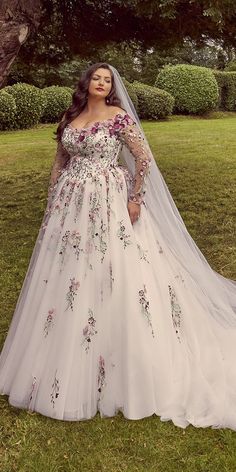 a woman in a wedding dress posing for the camera