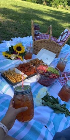 a picnic table with food and drinks on it