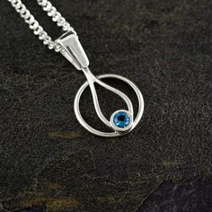 FLAMA pendant made in sterling silver with a polished finish. Handmade in our workshop. Silver chain 45 centimeters long. Natural round faceted London Blue Topaz stone 4 mm diameter. Elegance and design combine to create this pendant that stands out on its own. The blue topaz is associated with happiness, abundance, creativity and even vital energy. Although, undoubtedly, its main characteristic is that it is known as the stone of intelligence and spirituality.... We can customize the piece with other materials and finishes! We like to design for you and customize each piece as you like. We want you to take home just what you want. Silver Faceted Sterling Silver Birthstone Necklace, Faceted Sterling Silver Birthstone Necklace With Round Pendant, Sterling Silver Faceted Pendant Birthstone Necklace, Silver Teardrop Sterling Silver Birthstone Necklace, Silver Necklaces With Blue Topaz Birthstone, Silver Topaz Necklaces With Birthstone, Silver Blue Topaz Oval Pendant Necklace, Silver Topaz Birthstone Necklaces, Tiny Pendant Necklace