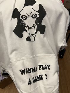 a white hoodie with the words wanna play a game on it