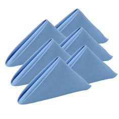 four blue napkins sitting on top of each other in front of a white background