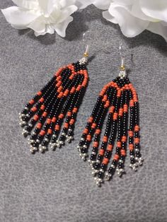 I heart you orange and black beaded fringed earrings great to wear any day! These earrings are made with high quality Czech seed beads in orange, black and silver, with a silver ear wire. 100% handmade in the heart of Oklahoma, with my passion for beading and attention to detail. Each piece can take hours to complete. Lightweight to wear! They would make a great gift for you or someone special. Great for Halloween as well! If you don't see a color you like, I can make you a custom pair. Just sen Black Heart Beads Dangle Jewelry, Orange Beaded Earrings With Black Beads, Orange Dangle Beaded Earrings With Black Beads, Orange And Black Beads Dangle Earrings, Orange Dangle Earrings With Black Beads, Black Beaded Fringe Earrings As Gift, Orange Earrings With Black Beads As Gift, Orange Dangle Jewelry With Black Beads, Orange Earrings With Black Beads For Gift