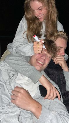 a woman is being hugged by a young boy