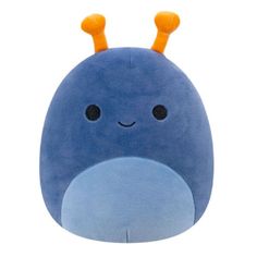 a blue stuffed animal with orange horns on it's head and eyes, sitting in front of a white background